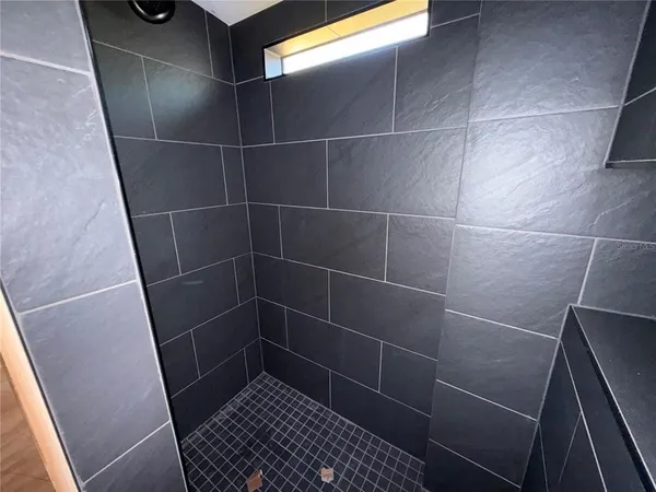 a bathroom with a light fixture and a window