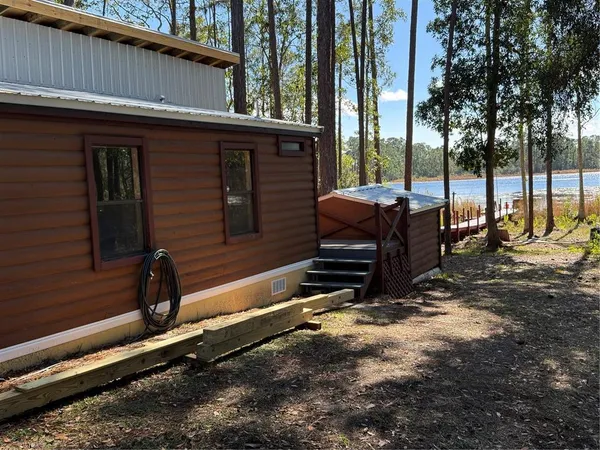 a view of a backyard with chairs and a grill
