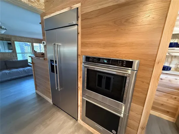 a kitchen with stainless steel appliances granite countertop a refrigerator and a stove top oven
