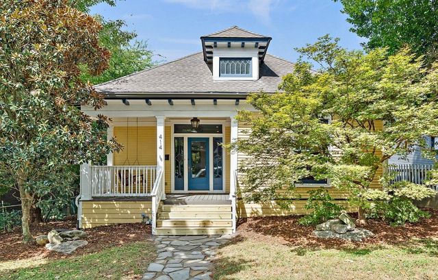 a view of a porch with a door and wooden floor
