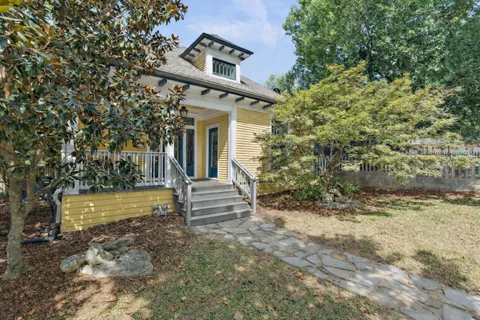 a view of a porch with a door and wooden floor