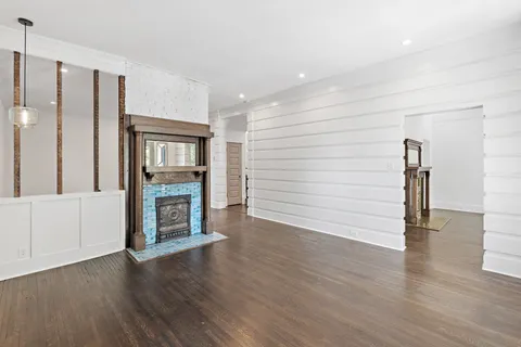 a dining room with stainless steel appliances kitchen island granite countertop furniture and a wooden floor