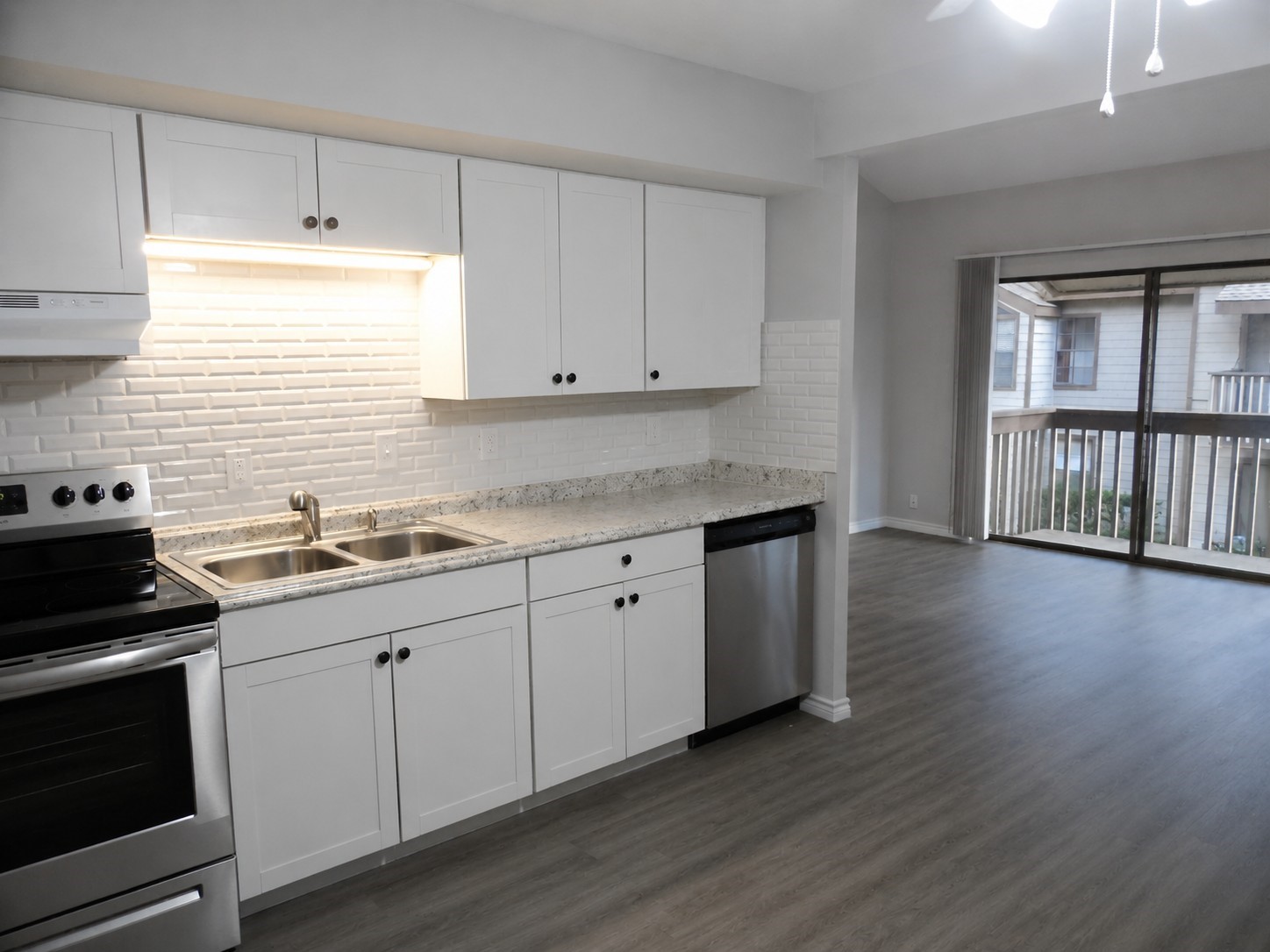 12900 Walden Road, Unit 618F Montgomery, TX 77356 - Photo 5 of 19 a kitchen with granite countertop a stove and a sink