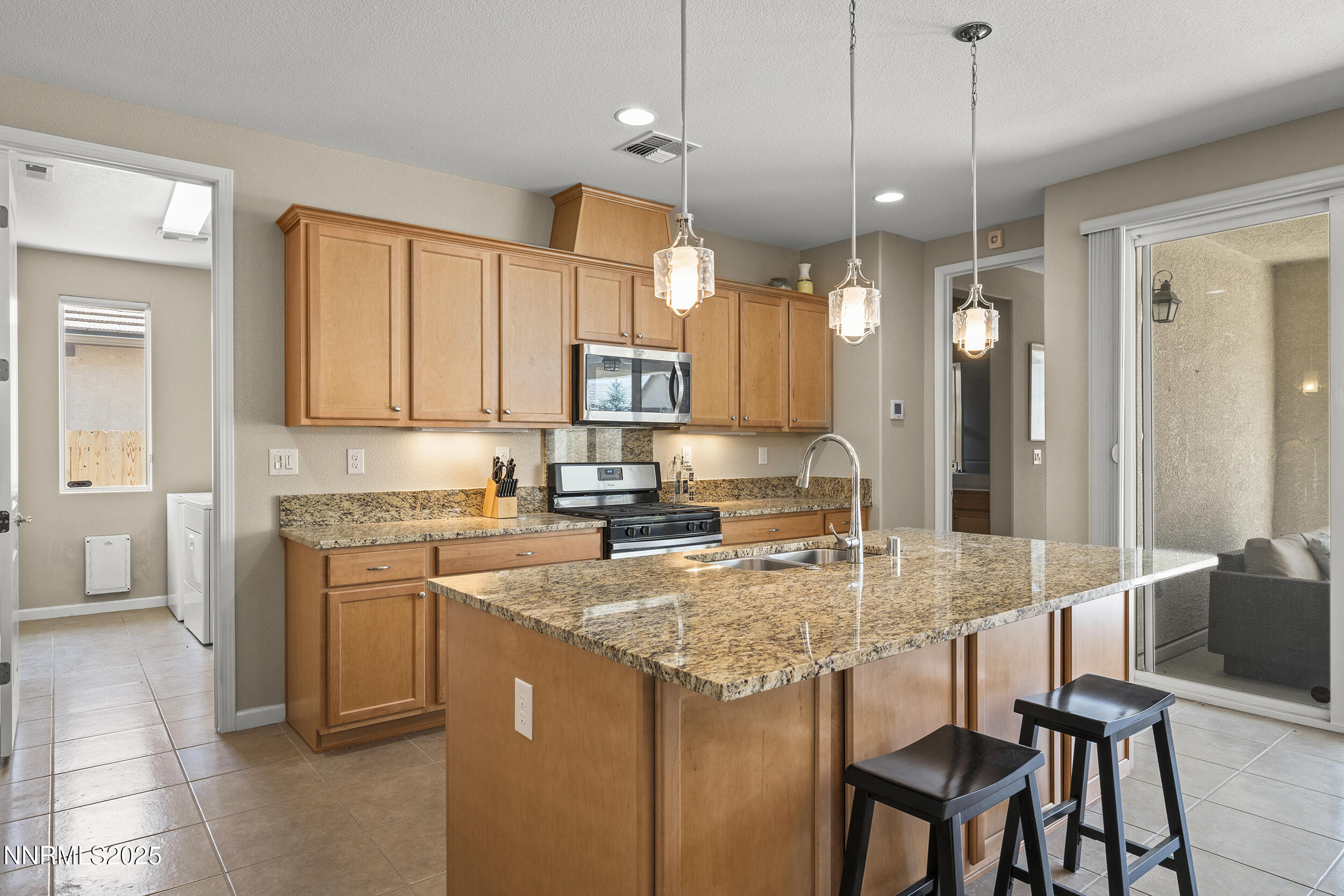 2280 Hyperion Lane Reno, NV 89521 - Photo 3 of 48 a kitchen with a table chairs refrigerator and microwave