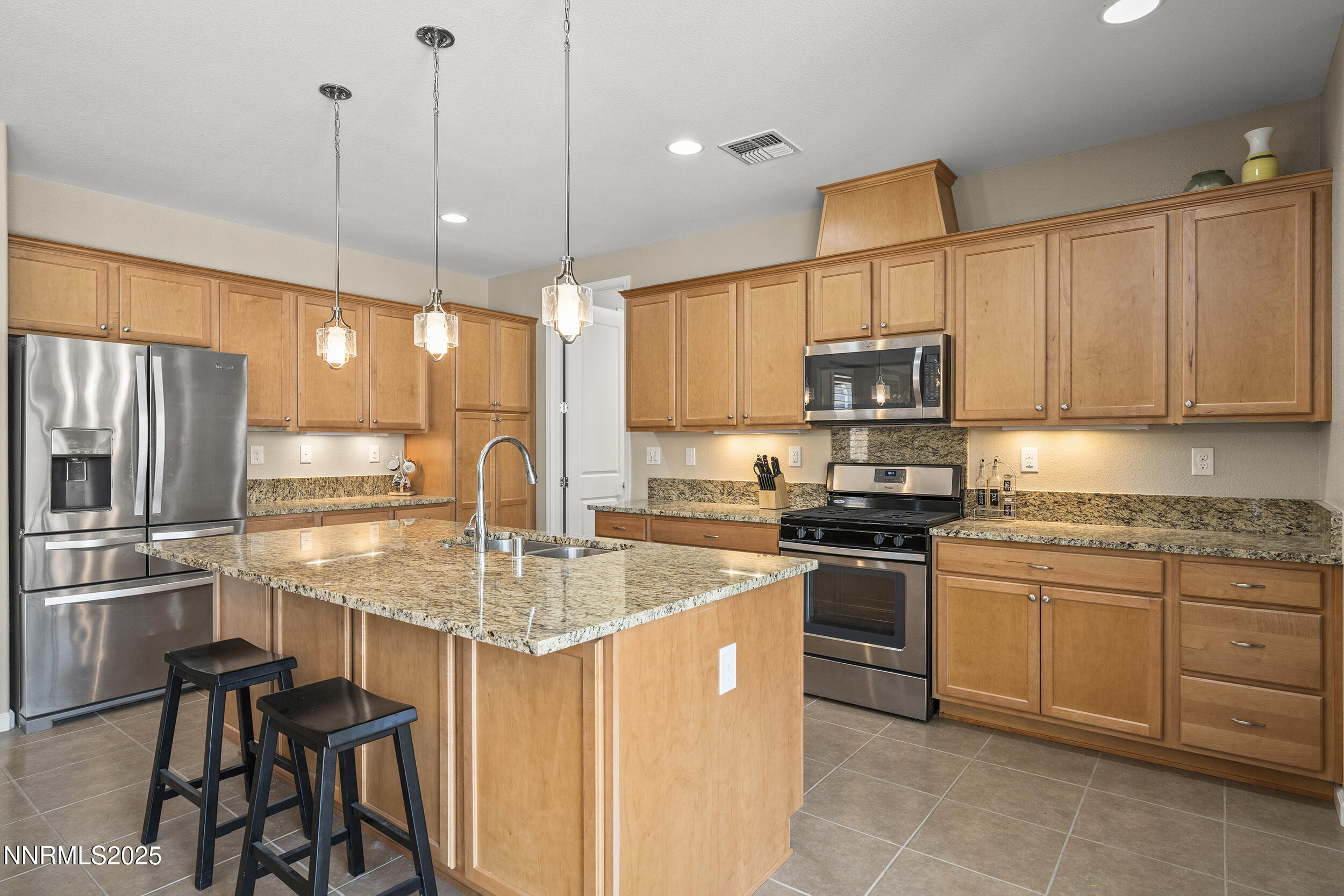 2280 Hyperion Lane Reno, NV 89521 - Photo 8 of 48 a kitchen with kitchen island granite countertop a stove sink and refrigerator