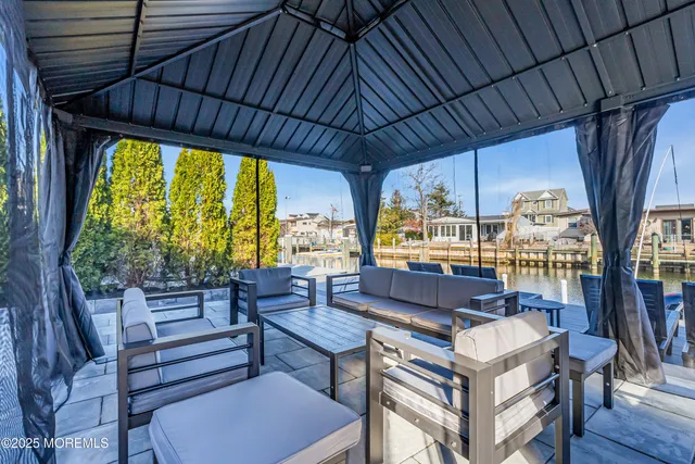 a bedroom with a large bed and a balcony next to a window