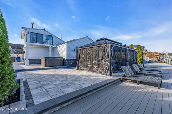a bedroom with a large bed and a balcony next to a window