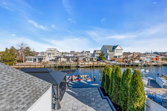 a open kitchen with stainless steel appliances granite countertop a stove and a wooden floors