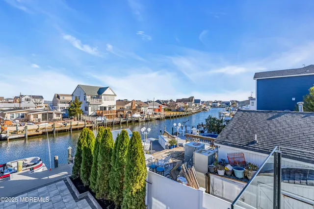 a large kitchen with stainless steel appliances granite countertop a large center island and a view of living room