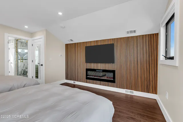 a view of a balcony with chairs and wooden floor