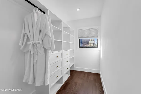 a view of a roof deck with couches and wooden floor