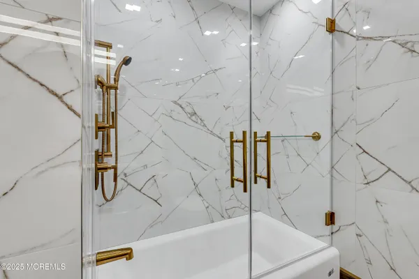 a bedroom with a bed and a flat tv screen on a dresser