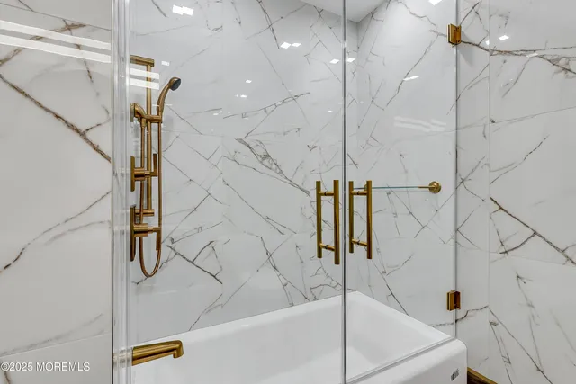 a bedroom with a bed and a flat tv screen on a dresser