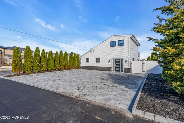 a view of a white house with a yard