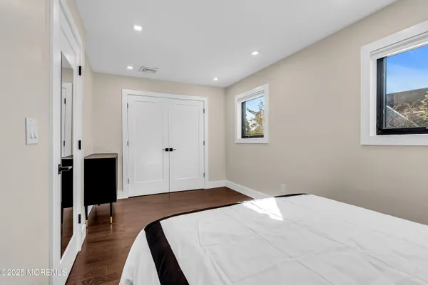 a large bed sitting in a bedroom next to a window