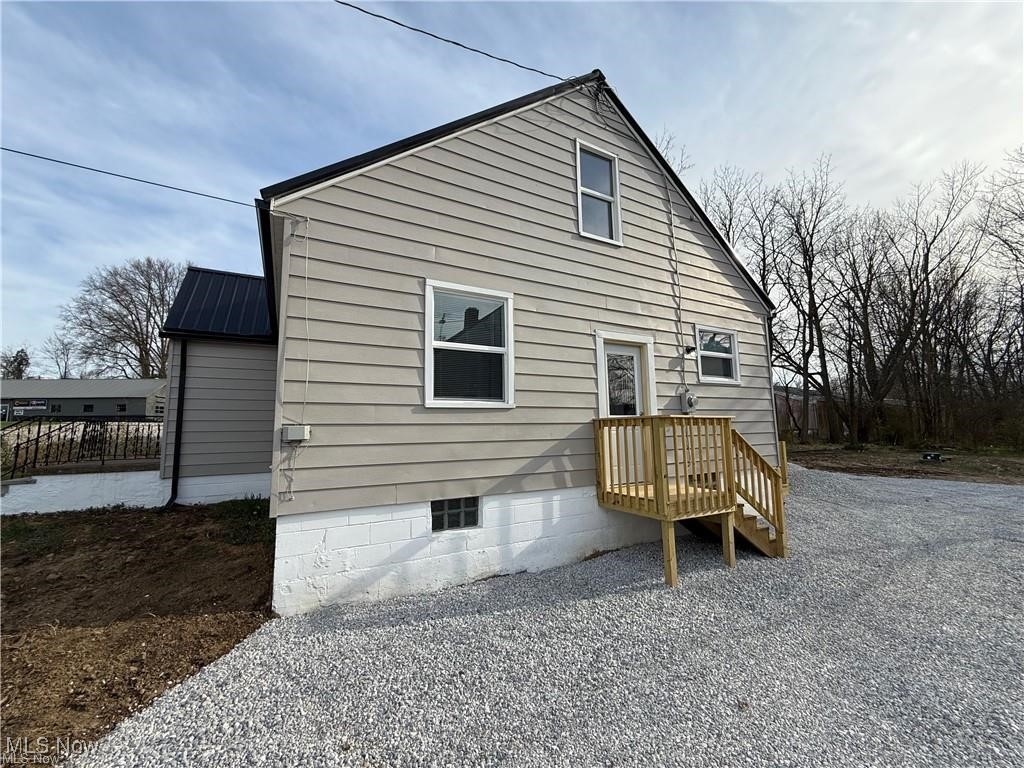 1644 Canton Road Akron, OH 44312 - Photo 22 of 25 Rear view of house featuring metal roof