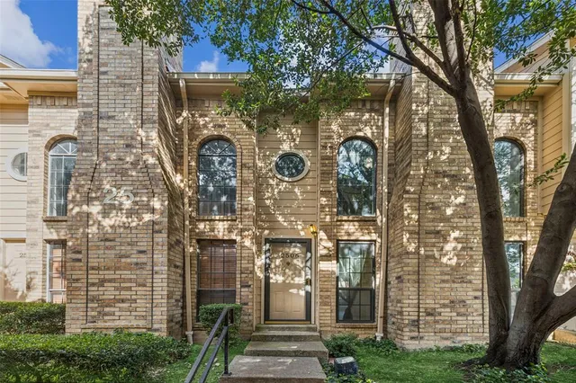 a front view of a house with trees