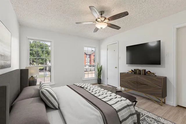 a bedroom with a bed and a flat screen tv