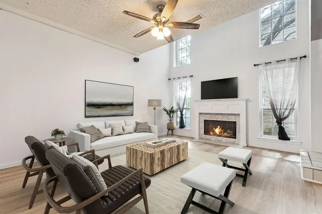 a living room with furniture a flat screen tv and a fireplace