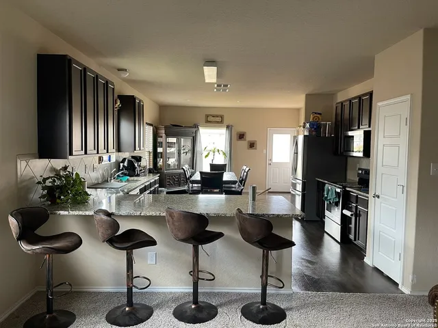 a room with lots of furniture and view of living room