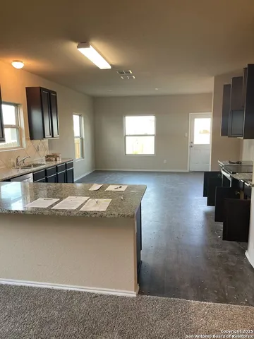 a view of a kitchen counter space and windows