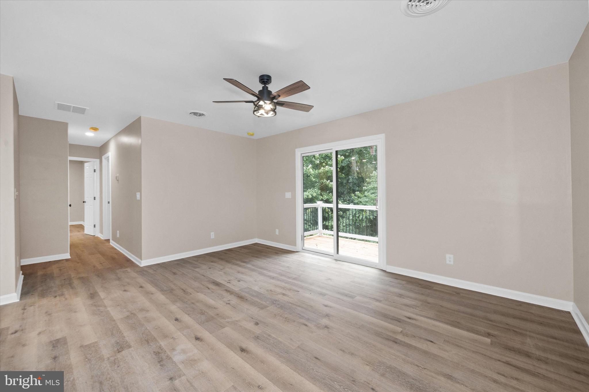 834 Willow Grove Road Felton, DE 19943 - Photo 14 of 48 a view of an empty room with a window and wooden floor