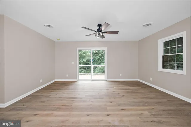 a spacious bedroom with a bed and a window