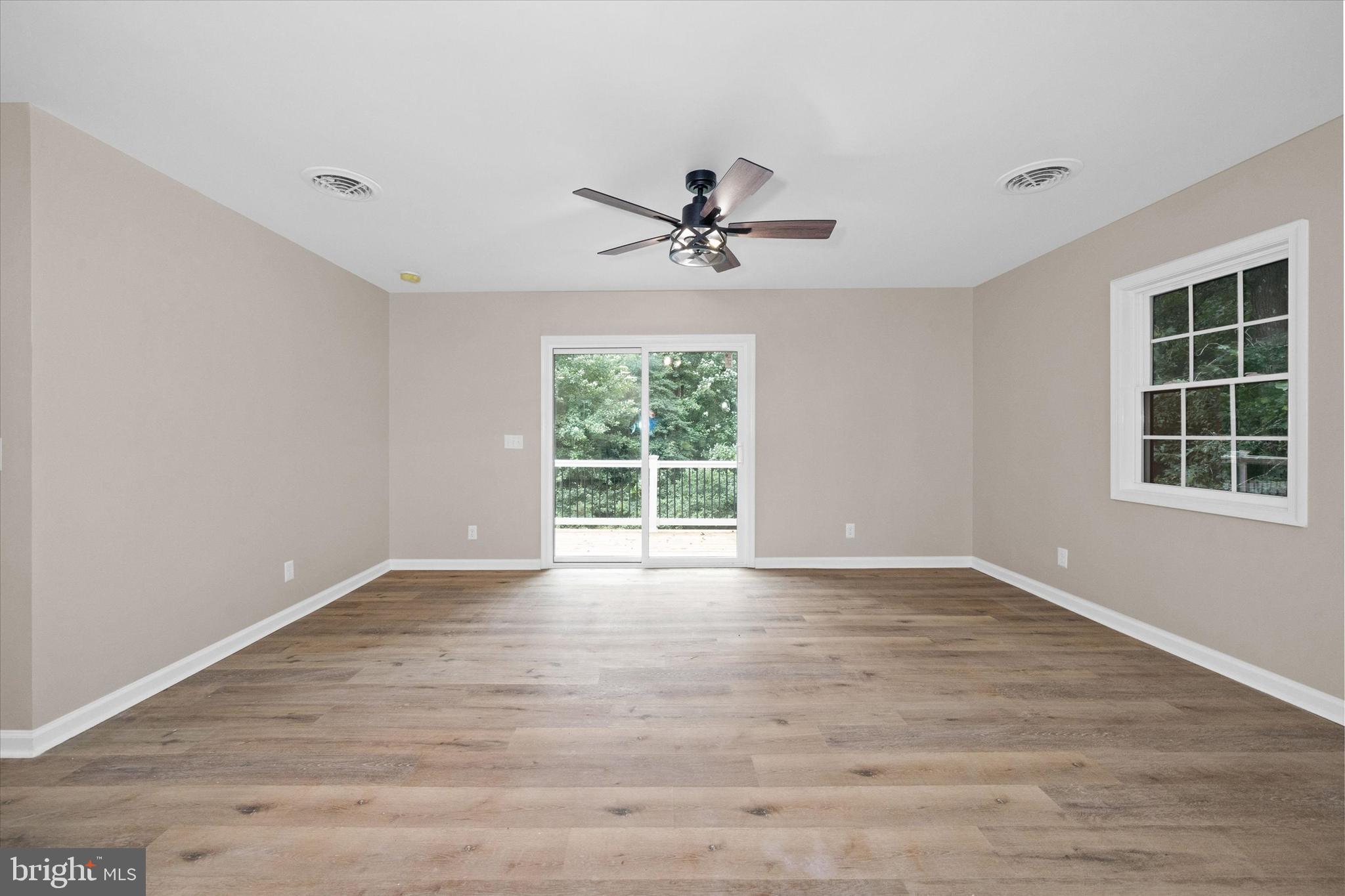 834 Willow Grove Road Felton, DE 19943 - Photo 15 of 48 a view of an empty room with a window and wooden floor