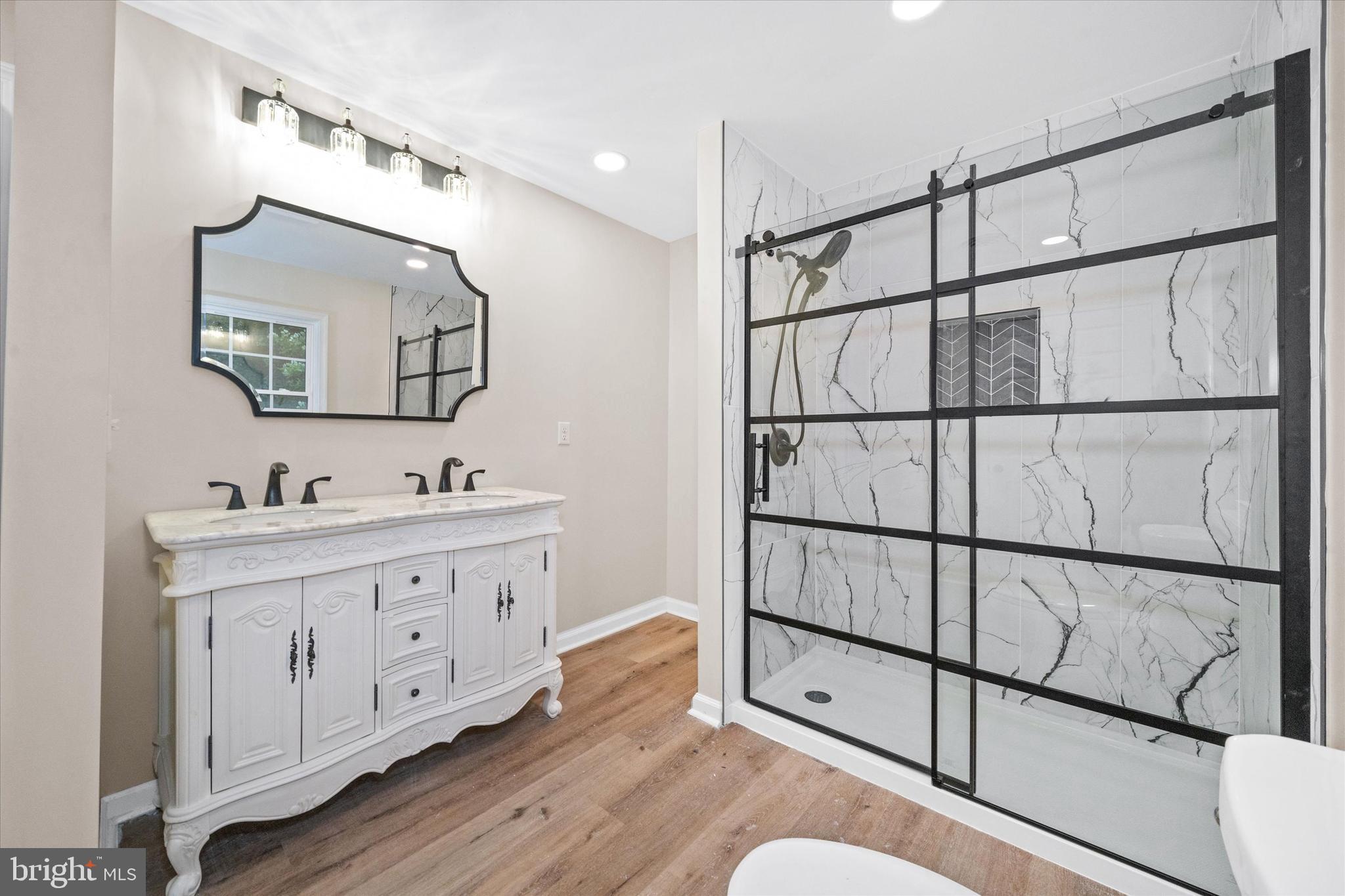 834 Willow Grove Road Felton, DE 19943 - Photo 20 of 48 a bathroom with a double vanity sink and a mirror