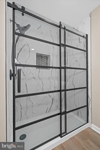 an empty room with a window and a ceiling fan