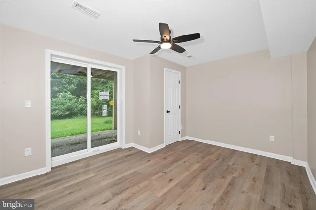 a view of an entryway with wooden floor