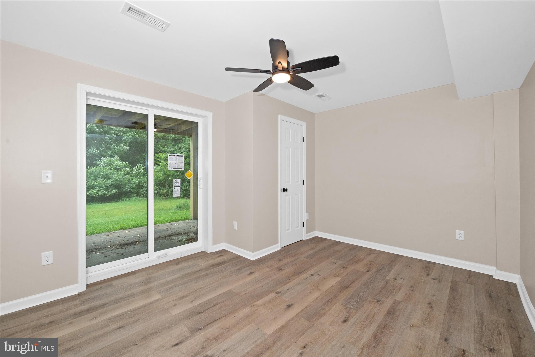 834 Willow Grove Road Felton, DE 19943 - Photo 29 of 48 a view of empty room with wooden floor and fan