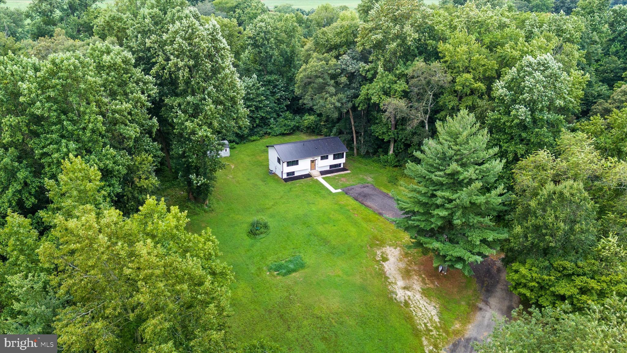834 Willow Grove Road Felton, DE 19943 - Photo 3 of 48 a backyard of a house with yard and trampoline