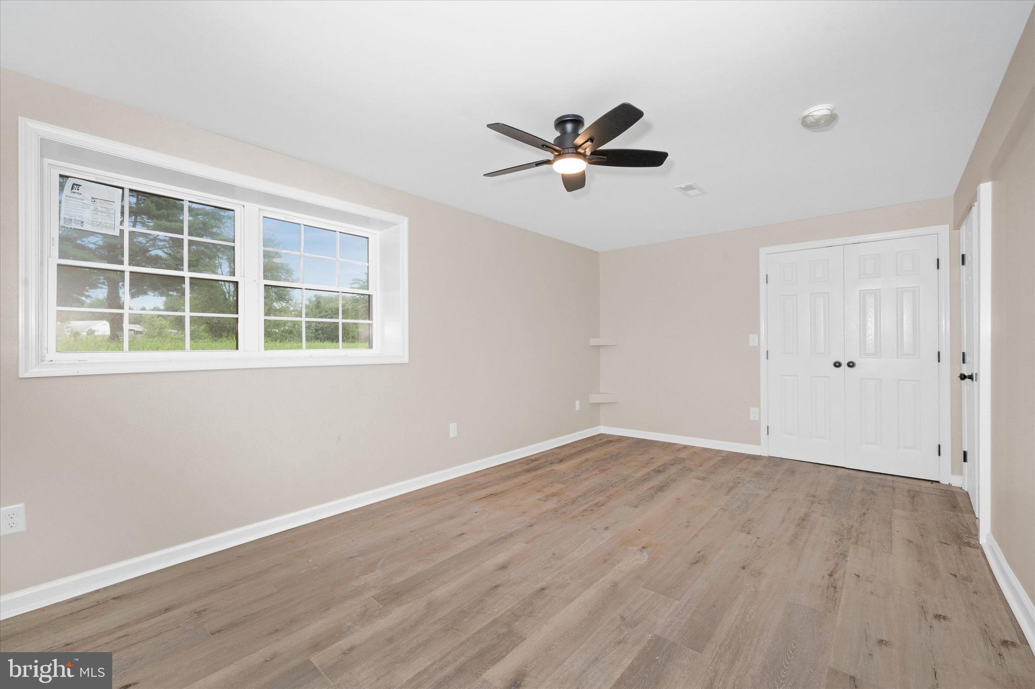 834 Willow Grove Road Felton, DE 19943 - Photo 32 of 48 a view of empty room with wooden floor and windows