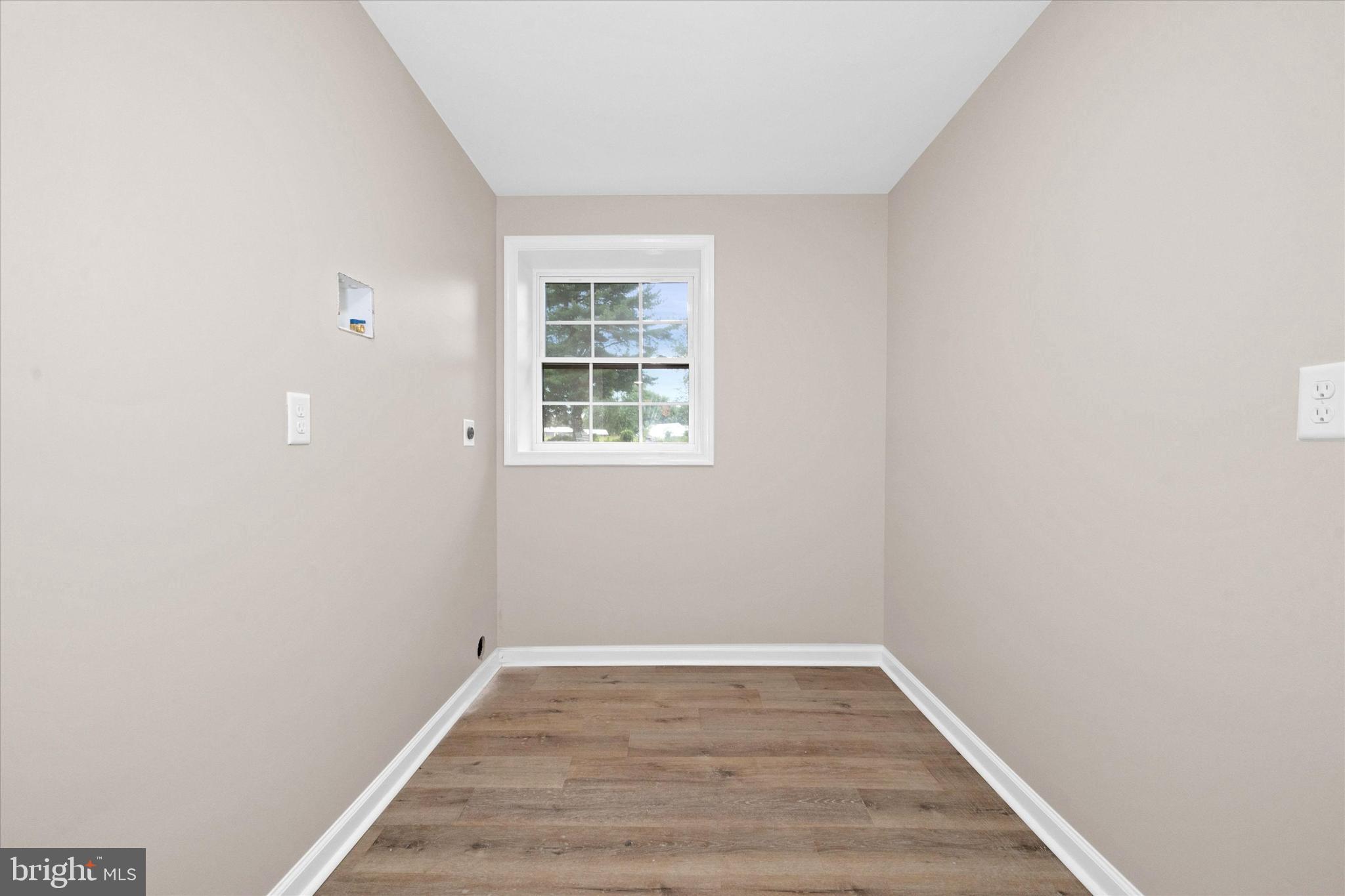 834 Willow Grove Road Felton, DE 19943 - Photo 34 of 48 a view of an empty room with wooden floor and a window