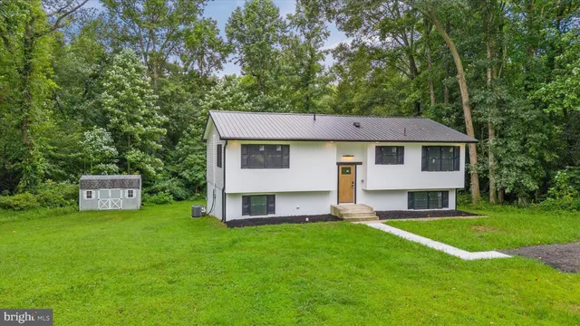 an aerial view of a house with a yard