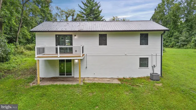 a white house that has a tree in front of it