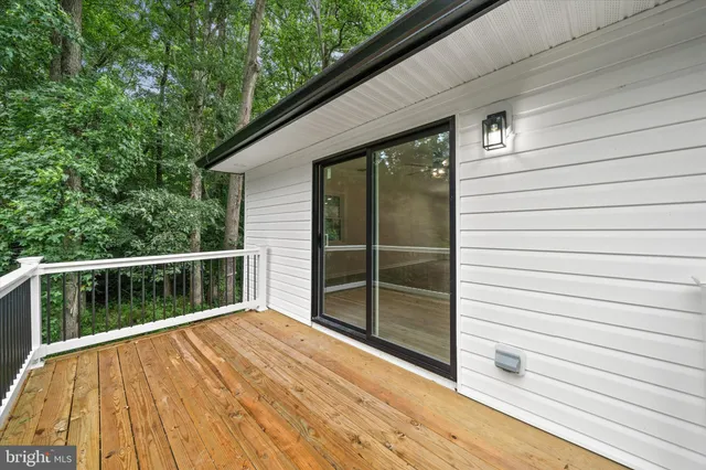 a view of balcony with wooden floor and fence