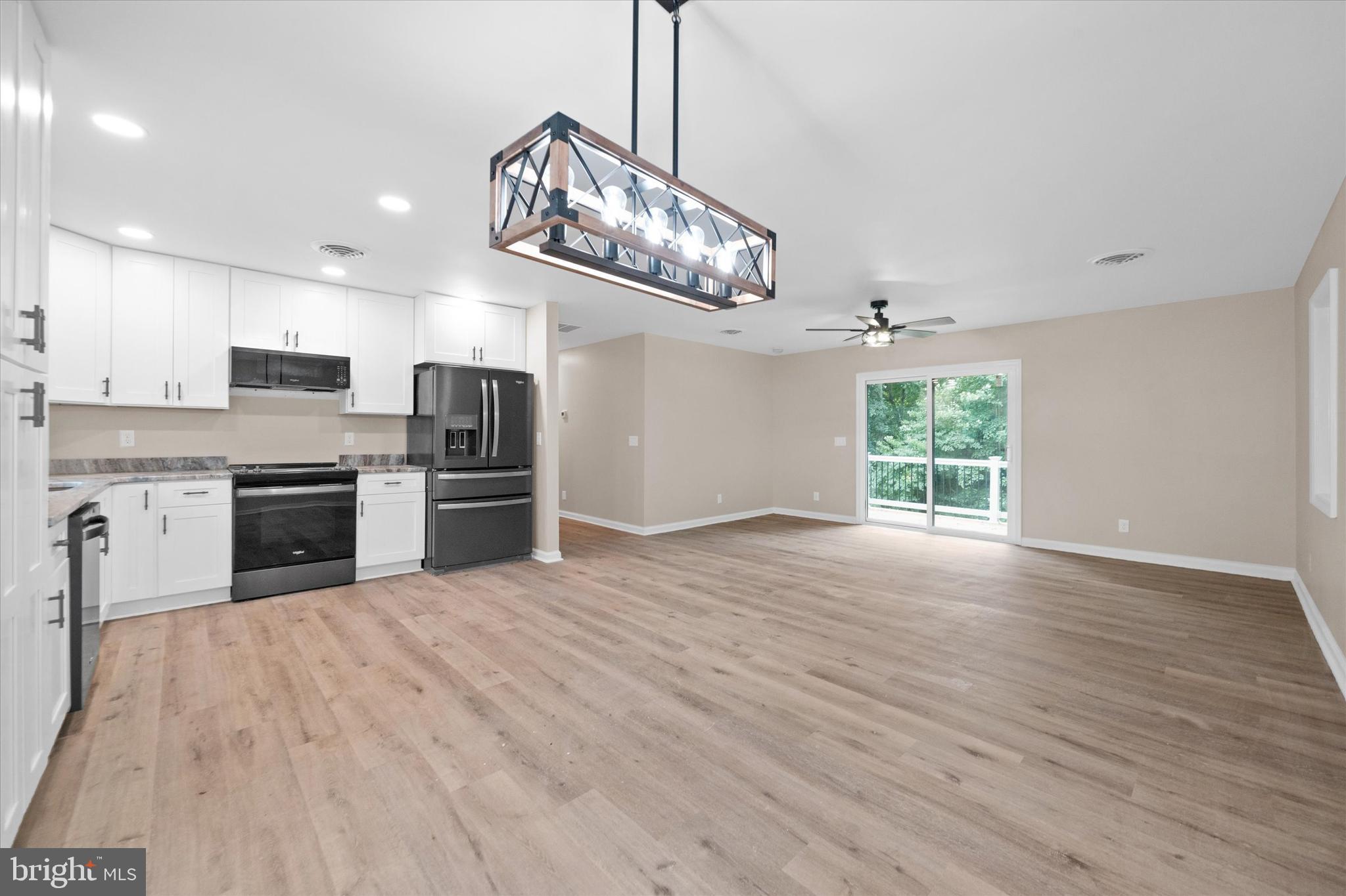 834 Willow Grove Road Felton, DE 19943 - Photo 8 of 48 a kitchen with stainless steel appliances granite countertop a stove top oven a sink dishwasher a refrigerator and white cabinets with wooden floor