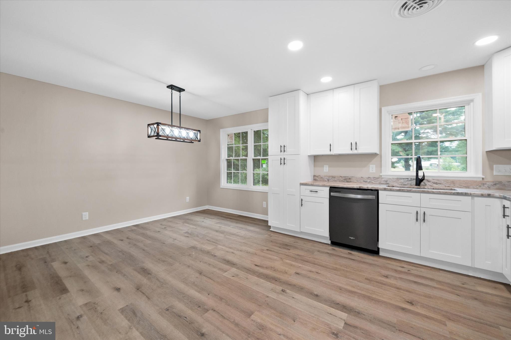 834 Willow Grove Road Felton, DE 19943 - Photo 10 of 48 a kitchen with granite countertop a stove a sink dishwasher a refrigerator and a oven with wooden floor