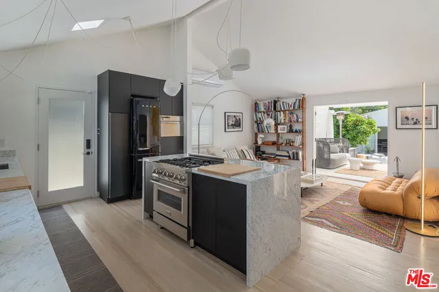 a kitchen with stainless steel appliances granite countertop a stove and a refrigerator