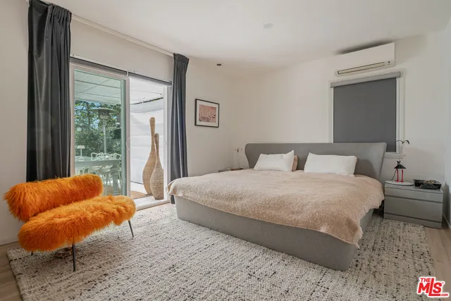 a bedroom with bed and a couch