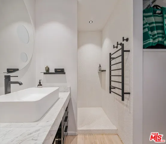 a bathroom with a tub sink and mirror