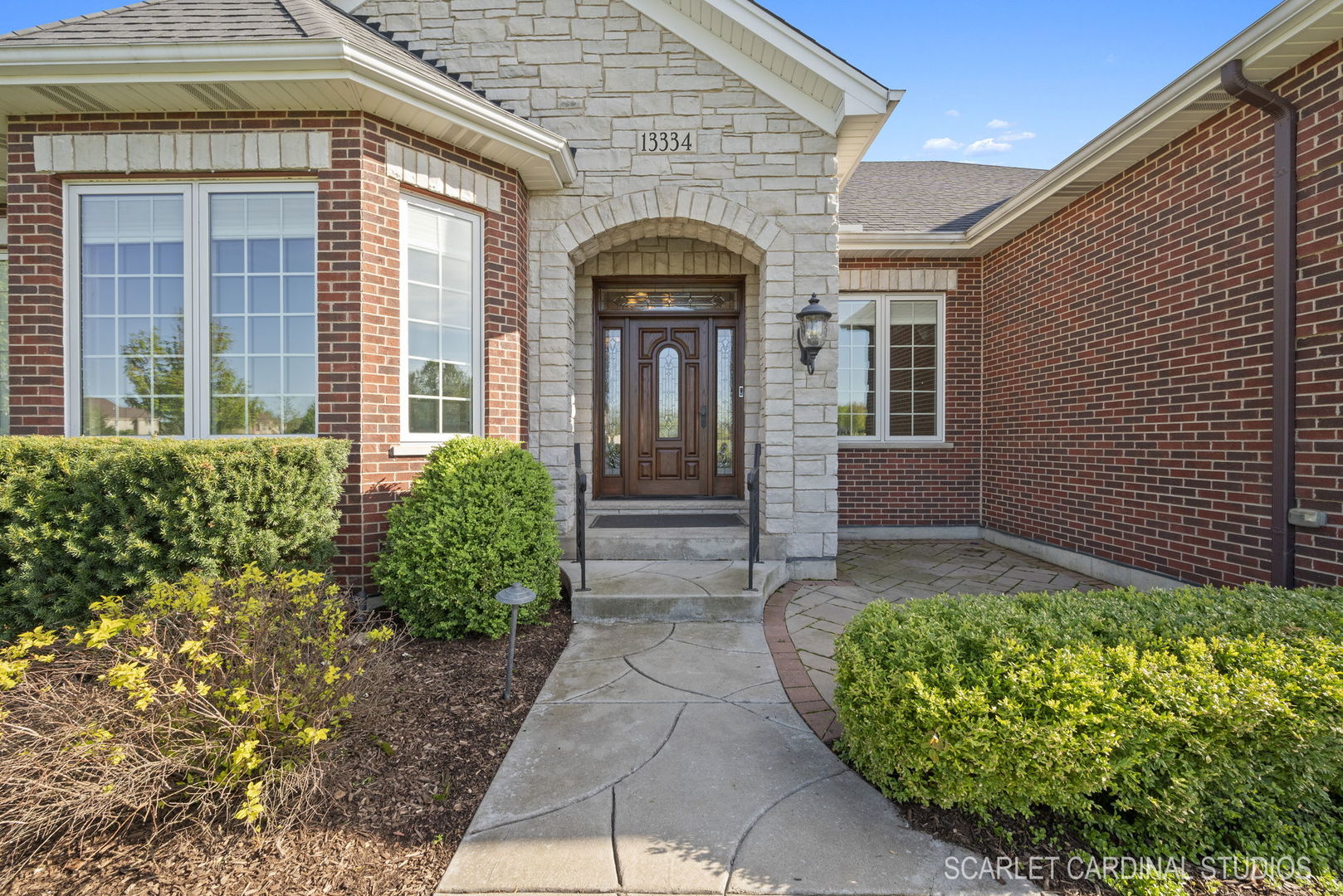 13334 Kerr Street Plainfield, IL 60585 - Photo 2 of 53 a front view of a house with garden