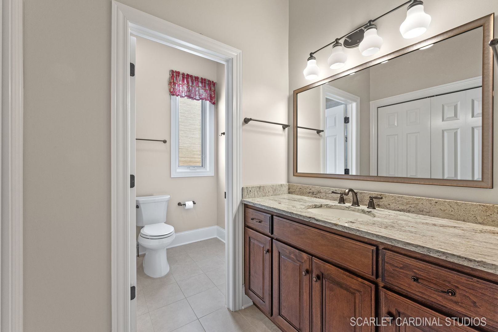 13334 Kerr Street Plainfield, IL 60585 - Photo 29 of 53 a bathroom with a granite countertop sink a toilet and a mirror