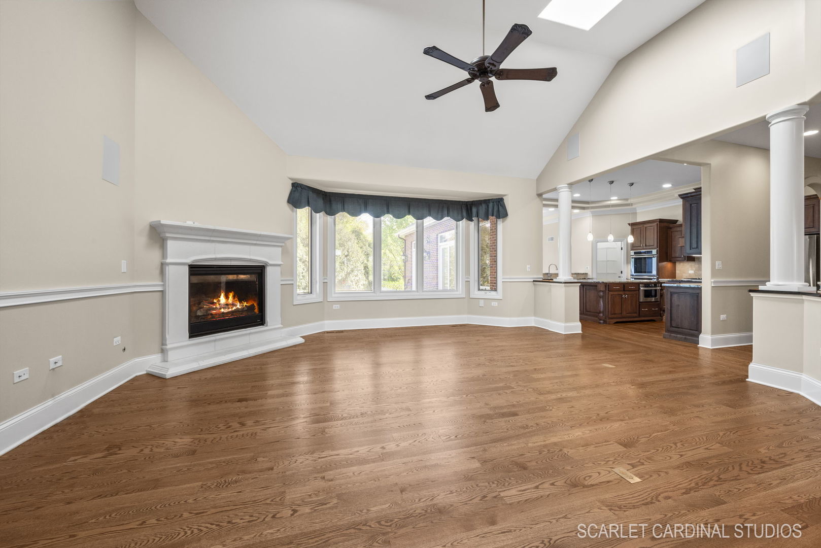 13334 Kerr Street Plainfield, IL 60585 - Photo 10 of 53 a view of a livingroom with a fireplace a ceiling fan and windows