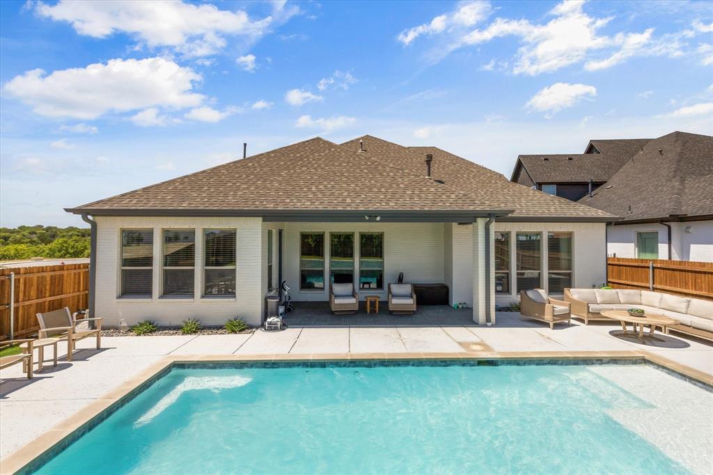 a view of a house with swimming pool and sitting area