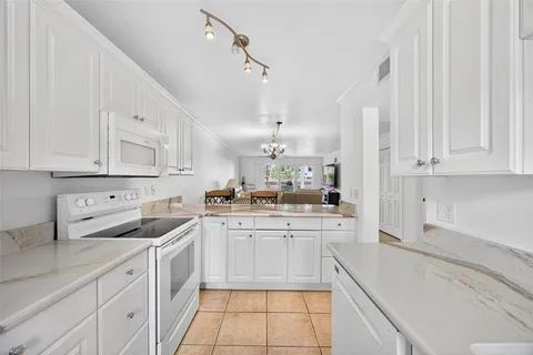 a room with a sink cabinets and utility
