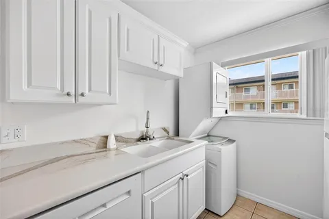 a kitchen with a sink cabinets and window