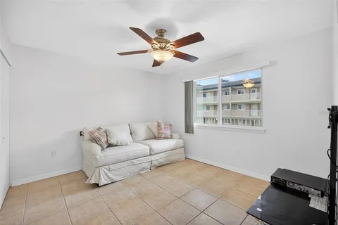 a living room with furniture and a ceiling fan